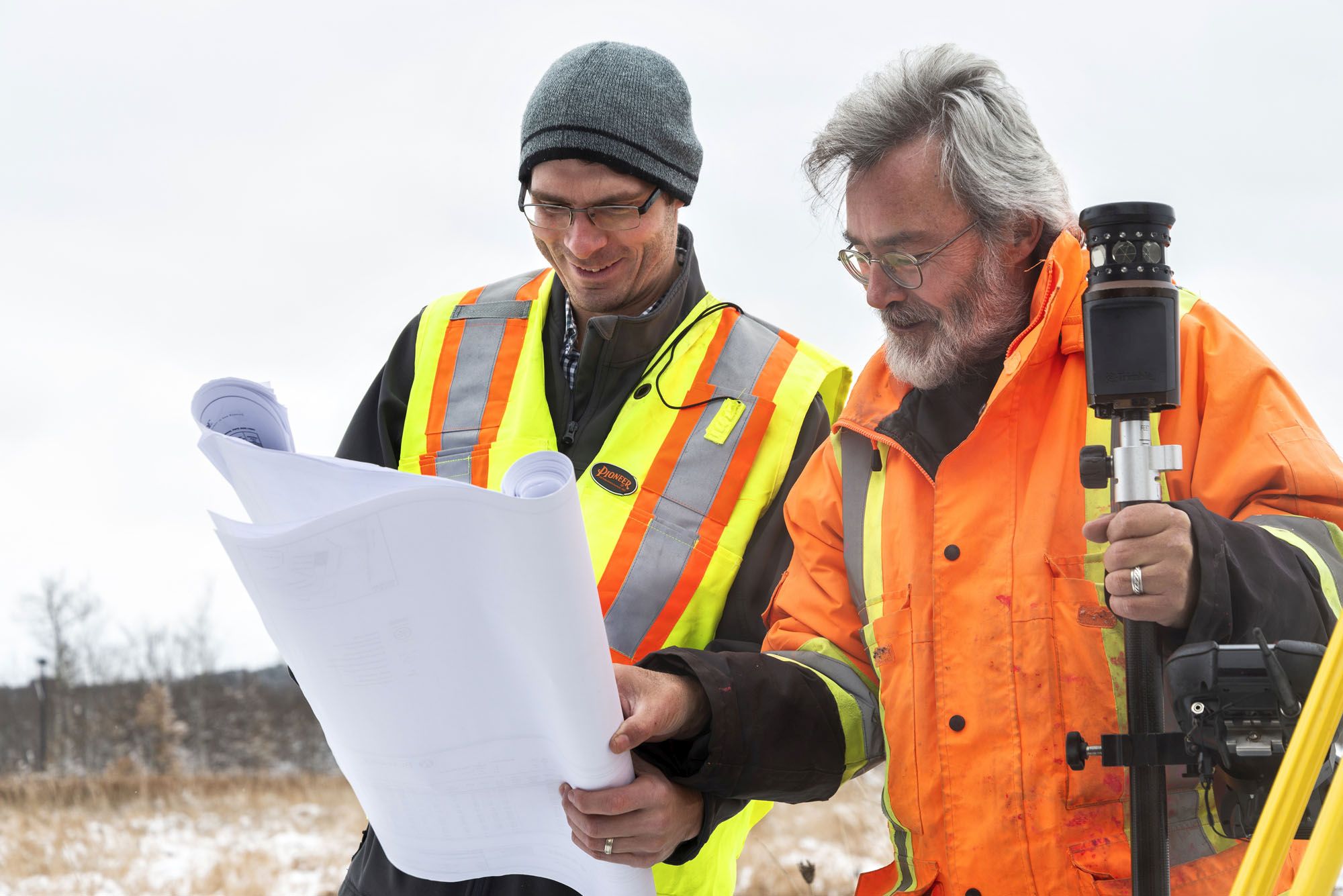 two construction workers looking at drawings